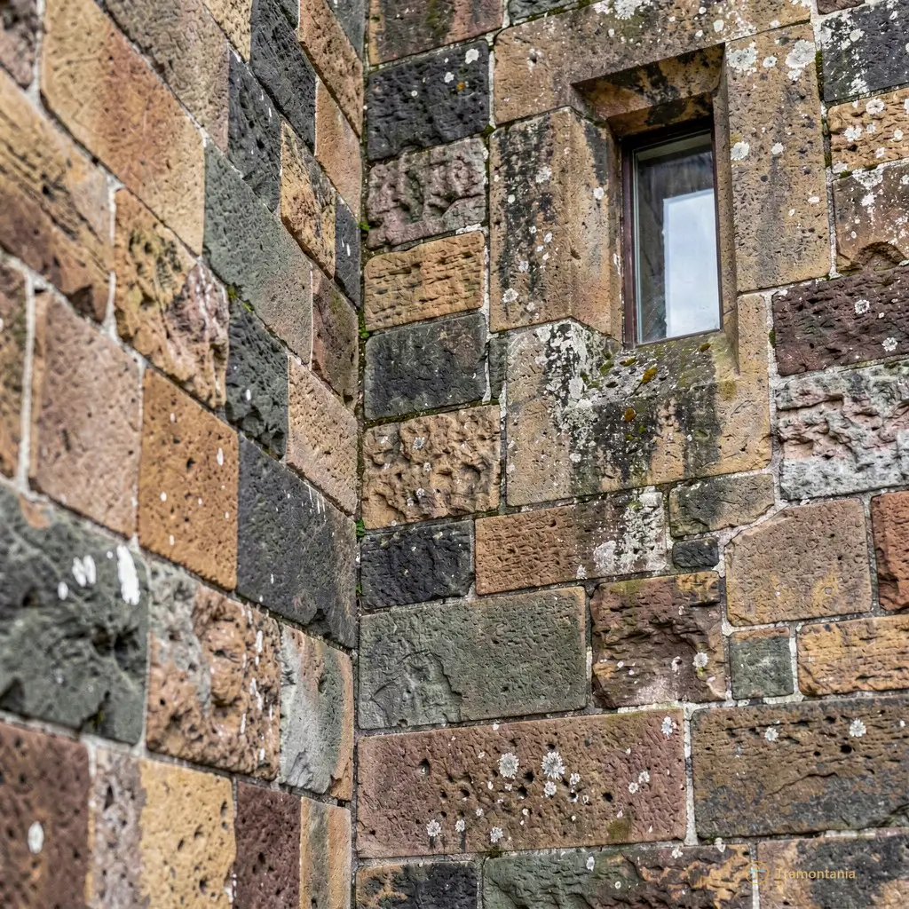 Close-up detail of the fortress walls showing weathered stone texture and a small window embrasure